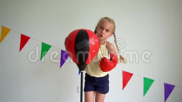 白种人小女孩打拳击梨机智拳击手套慢动作视频的预览图