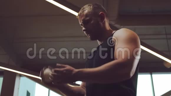 运动英俊的男性运动员在健身房工作使用滑石粉强壮健康的腹部健美视频的预览图