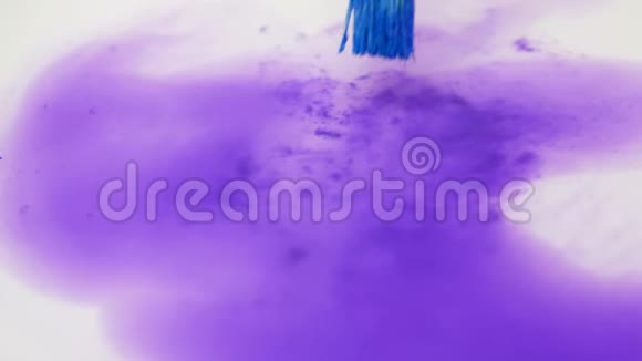 艺术家清洁彩色画笔在清水中涂抹紫罗兰色视频的预览图