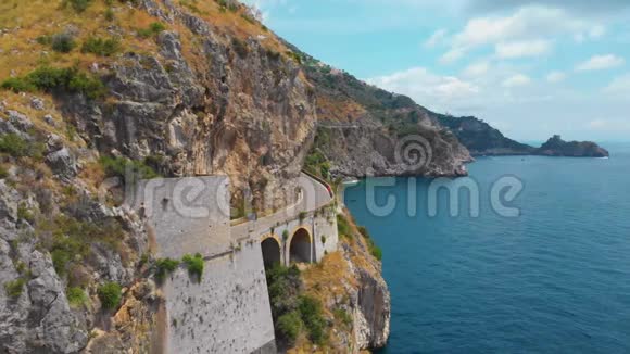 意大利南部山区一条蜿蜒的公路的全景海面上陡峭的悬崖危险的行动黑色汽车视频的预览图