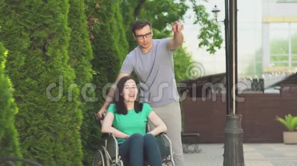 年轻人和一个坐轮椅的残疾女孩去散步视频的预览图