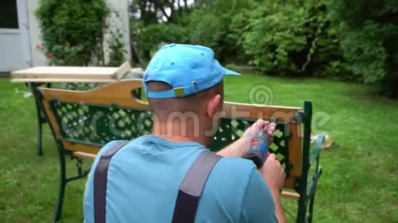 木匠用螺丝刀拆卸复古长凳室外家具视频的预览图