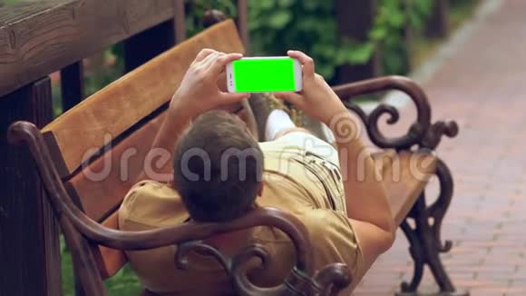 男人用手机在夏日阳光下放松视频的预览图