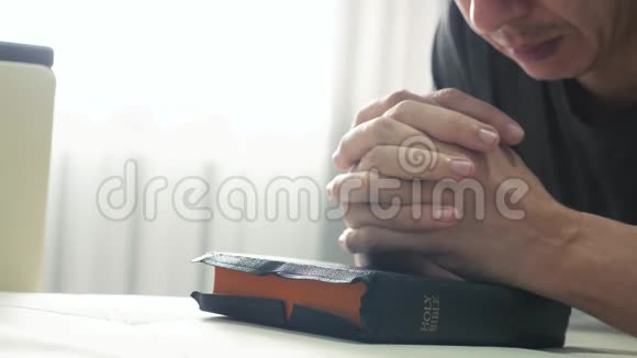 人们在睡前在室内祈祷圣经的生活方式宗教概念晚祷人类深色手圣经视频的预览图
