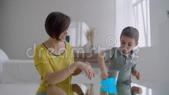 笑着母子俩在一起在公寓里玩家庭幸福明亮的内部视频的预览图