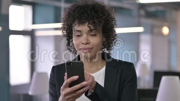 使用智能手机的非洲快乐女商人画像视频的预览图