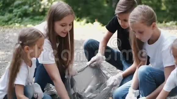 一群戴手套的孩子在城市公园捡垃圾视频的预览图