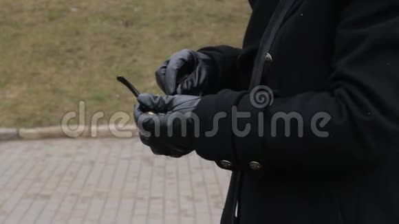 一个穿着黑色外套的男人的手塞了起来视频的预览图