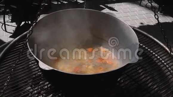 在街上的一个大锅里一个海鲜和蔬菜汤的特写镜头慢镜头视频的预览图