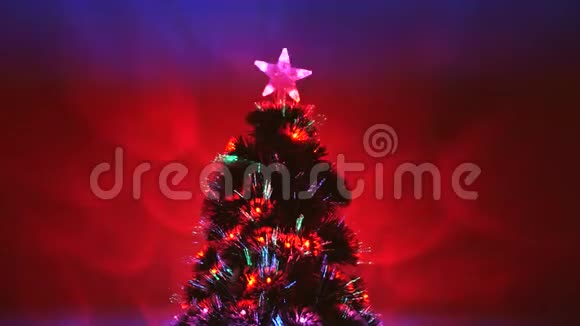 神奇的圣诞人造树房间里有一颗星星装饰着一个发光的多色花环新年视频的预览图