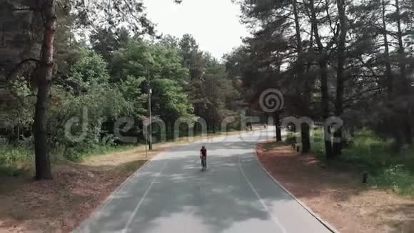 自信专注的年轻迷人的女孩正在公园里骑自行车训练铁人三项的概念前方跟射术视频的预览图