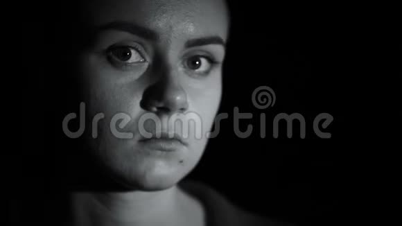 可耻的女人在黑暗的背景下看着摄像机羞辱受害者视频的预览图