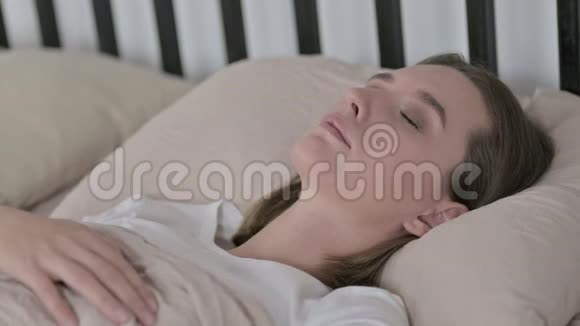 生病的青年妇女在床上咳嗽视频的预览图