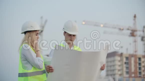 两位工程师讨论看施工图图纸和指定具体施工对象的位置视频的预览图