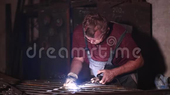 焊工在车间焊接金属围栏慢动作无防护面罩视频的预览图
