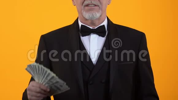 快乐优雅的男人伸出大拇指手里拿着美元赌场赢家视频的预览图