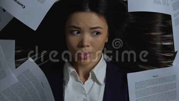 哭泣的女经理关闭脸躺在文件下新的商业项目视频的预览图