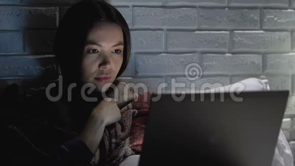 患流感的女性在笔记本电脑前被人用毛毯咳嗽视频的预览图