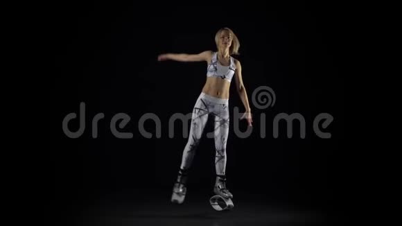 精力充沛的女孩在kangoo跳鞋上表演练习慢动作视频的预览图