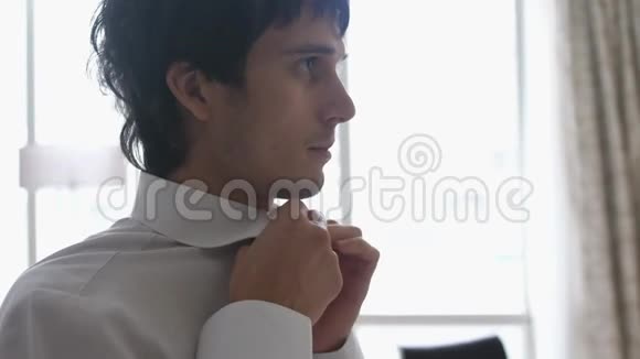 男士穿衣纽扣白衬衫领子视频的预览图