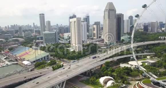 新加坡飞艇和该区的空中镜头无人驾驶飞机从摩天轮驶过新加坡高速公路视频的预览图