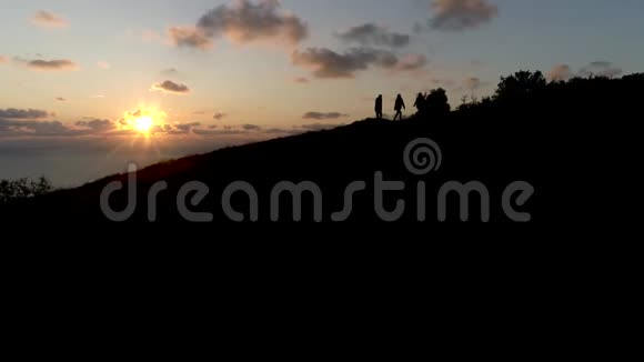 神圣的日落时三个人靠海爬山总计划视频的预览图