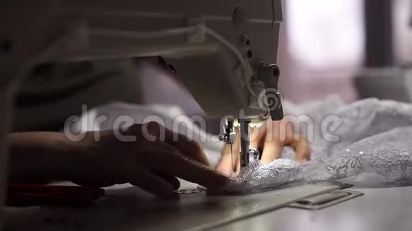 工作缝纫背光机缝制白色花边裁缝手切线紧紧地弯着腰背景模糊视频的预览图