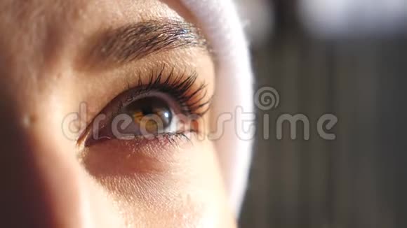 棕色眼睛的女人脸上的细节视图欣赏美丽的冬天景色漂亮的棕色眼睛女孩眨着眼睛视频的预览图