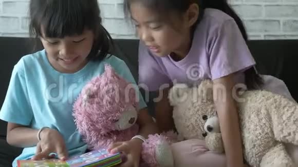 亚洲儿童女孩在家里的客厅里读故事视频的预览图