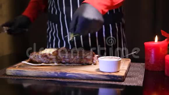 新年桌上的排骨眼牛排一个戴手套的侍者切了一块多汁的牛排餐厅厨师切片中稀牛排视频的预览图