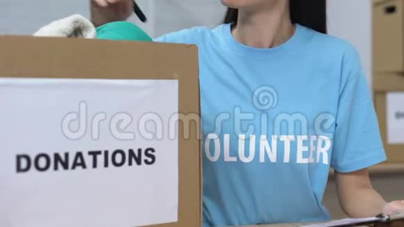 女性志愿者制作捐赠衣物和微笑慈善捐款清单视频的预览图