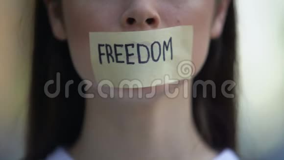 女士用自由的话语取下磁带抗议歧视视频的预览图