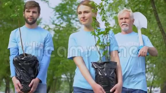 生态志愿者家庭带着树苗和铲子在公园散步园艺视频的预览图