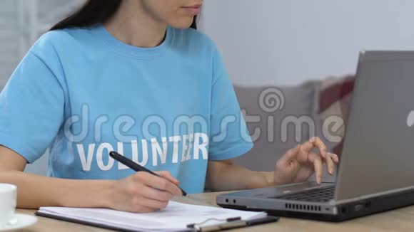 年轻女士自愿在笔记本电脑上工作并制定清单规划预算视频的预览图