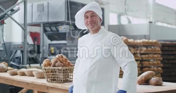 在一家面包店里他两手交叉享受着工作中的时光笑容满面视频的预览图