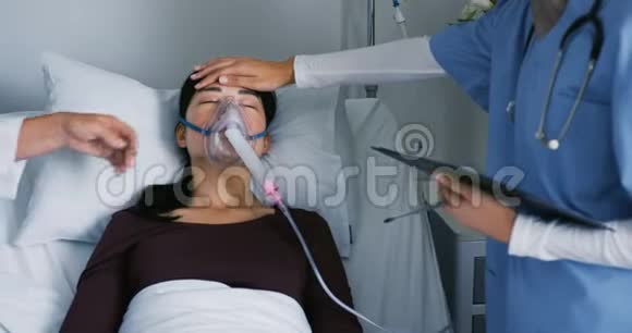 两名医生在病床上照顾一名女病人视频的预览图