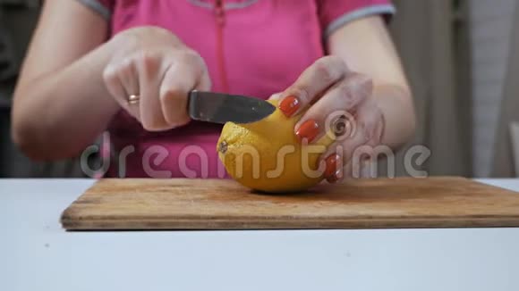 在木切割板上切柠檬女人切柠檬片视频的预览图