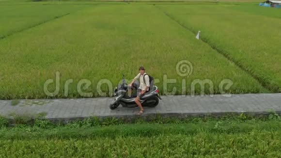 一名男子骑摩托车在稻田上的空中射击视频的预览图