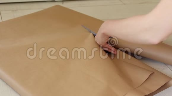 女性手把礼物包在工艺礼品纸上视频的预览图