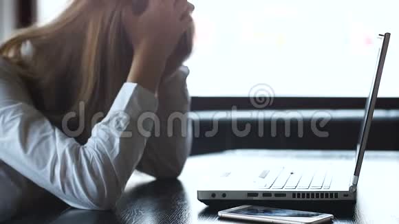 被压的女人抱着头愤怒地关闭笔记本电脑失败的启动项目视频的预览图