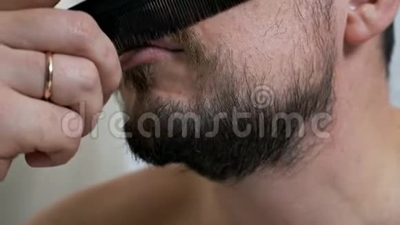 护肤的概念一个留着胡子的人或一个刮胡子的人在镜子前照顾他的外表视频的预览图