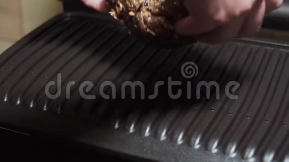 女性的手把用草药和香料腌制的肉铺在电烤架上视频的预览图