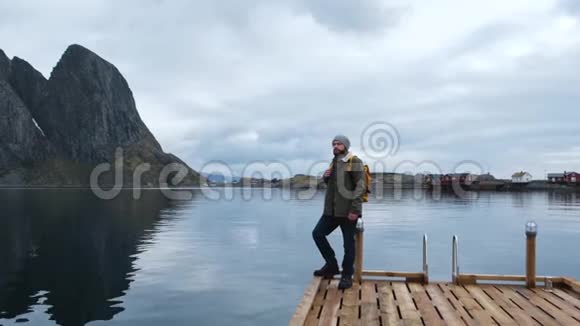 男游客站在木墩上凝视着美丽的风景令人惊叹的海洋平静的水面高视频的预览图