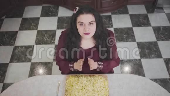 俯视肖像可爱的白种人胖女人准备吃面条丰满的女人在晚餐前祈祷肥胖的女士视频的预览图