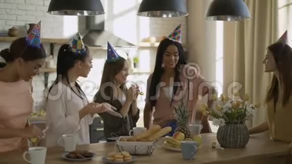 五个朋友庆祝生日戴着纸帽和带管子的女人在4k大盒子里送朋友礼物视频的预览图