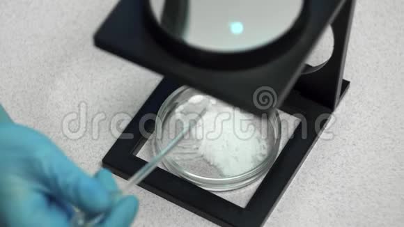 科学化学和人的概念在培养皿中用玻璃和化学粉末接近科学家的手视频的预览图