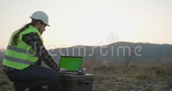 建筑工人白种人戴着安全帽使用带有色度键显示器的笔记本电脑视频的预览图