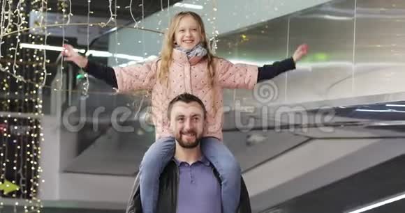 快乐的爸爸在购物中心里抱着一个漂亮的女学生视频的预览图