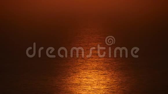 在炎热的夏日美丽的日落反射在海浪中视频的预览图