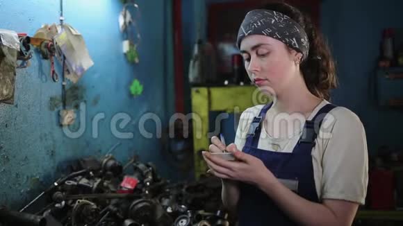 性别平等的概念一个年轻漂亮的女人穿着工作制服在机器上工作框架模糊了然后来了一个视频的预览图